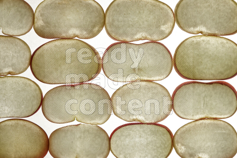 Peach slices on illuminated white background