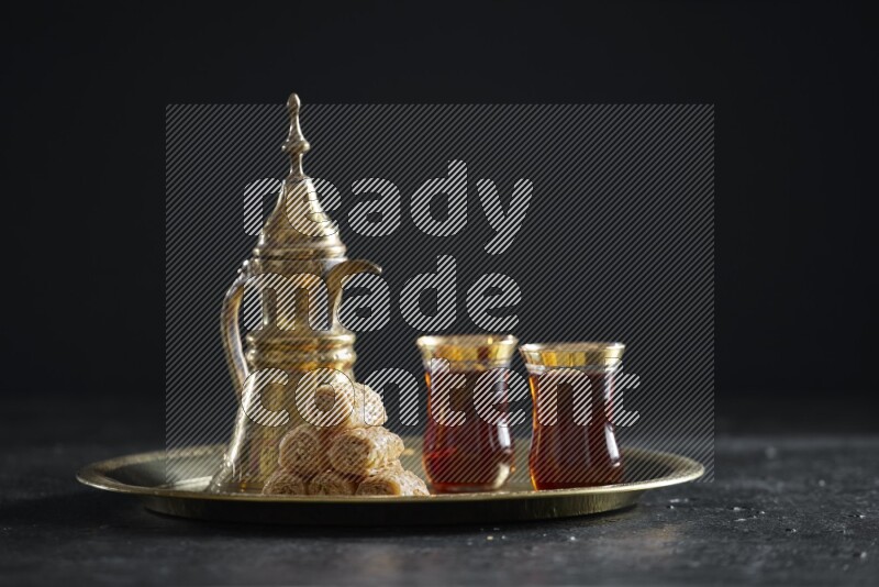 Golash with a drink on a metal tray in a dark setup