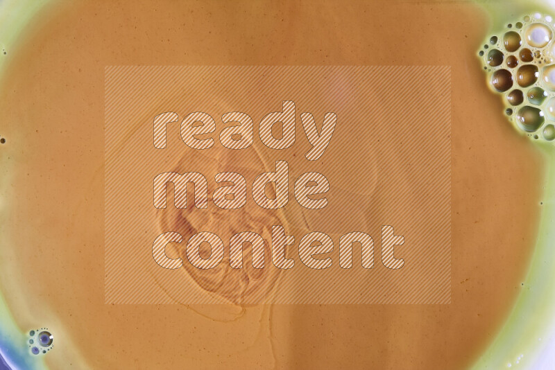 A close-up of abstract different swirling patterns in orange