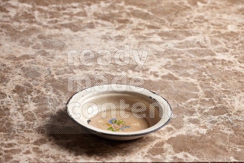A vintage metal plate on beige marble background
