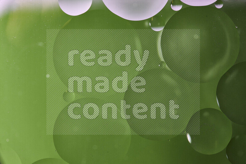 Close-ups of abstract oil bubbles on water surface in shades of white and green