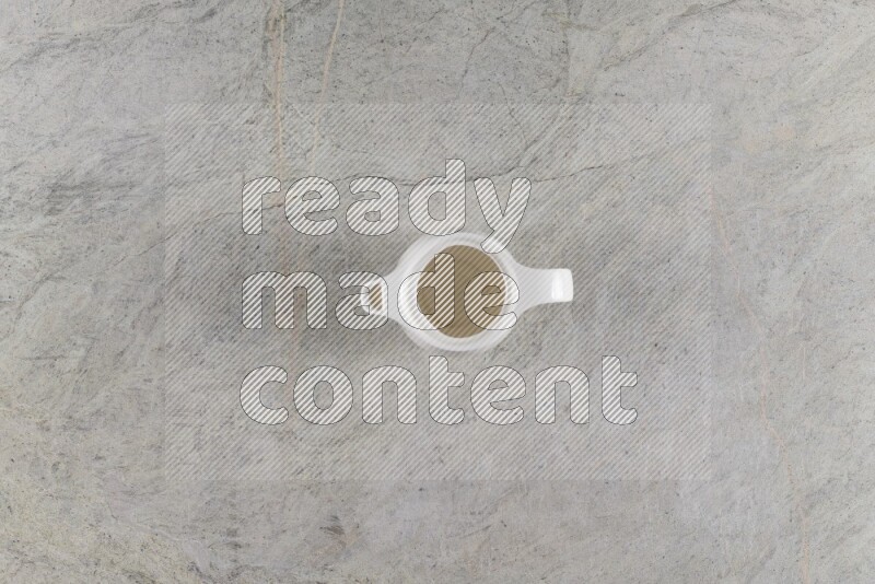 A ceramic milk jug on grey marble background