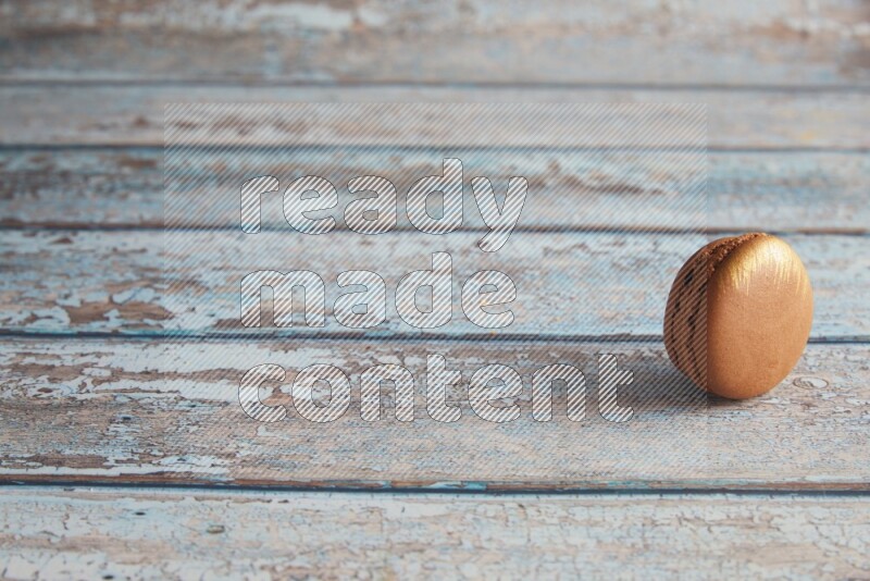 45º Shot of Brown Coffee macaron on light blue wooden background