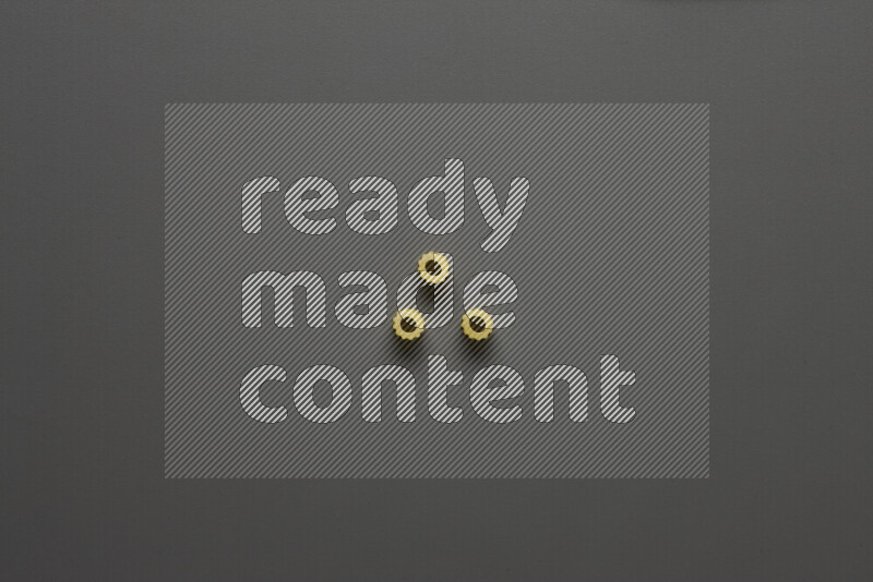 Small rings pasta on grey background
