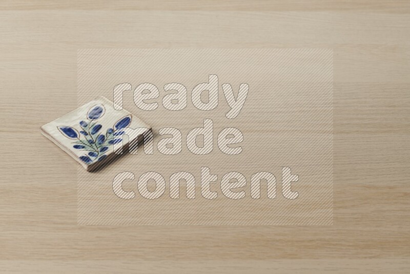 A decorative coaster on light wooden background