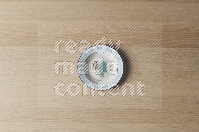 A vintage metal plate on light wooden background