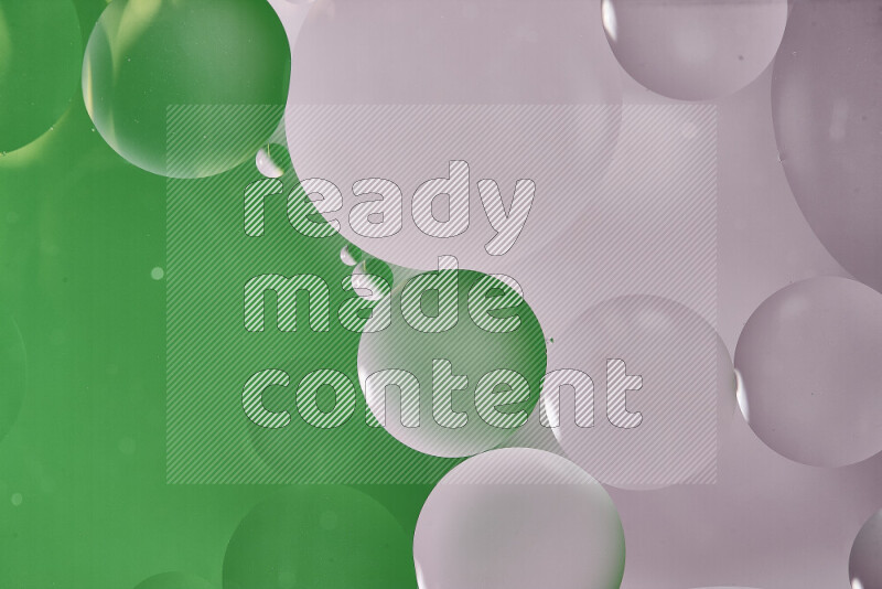 Close-ups of abstract oil bubbles on water surface in shades of white and green