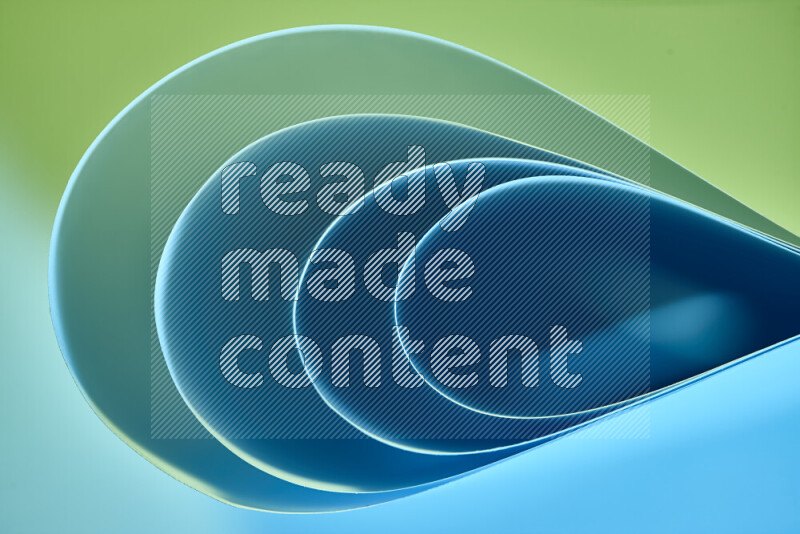 An abstract art of paper folded into smooth curves in green and blue gradients