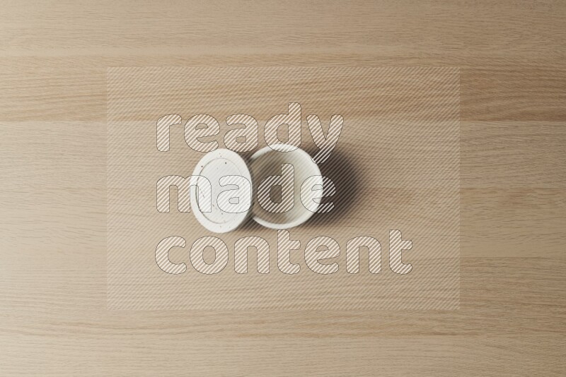 A white pottery bowl on light wooden background
