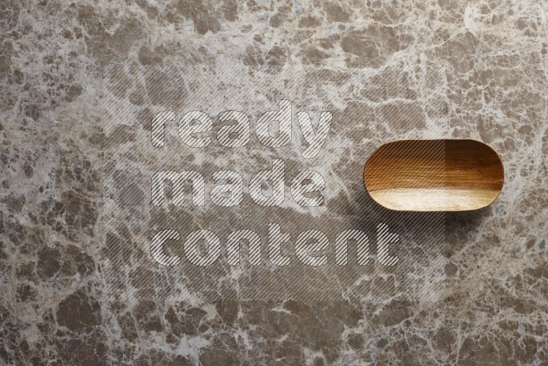 A wooden plate on beige marble background