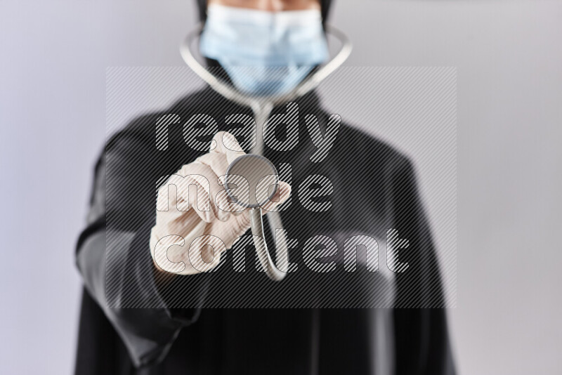 Female doctor wearing an abaya and medical attire in different positions