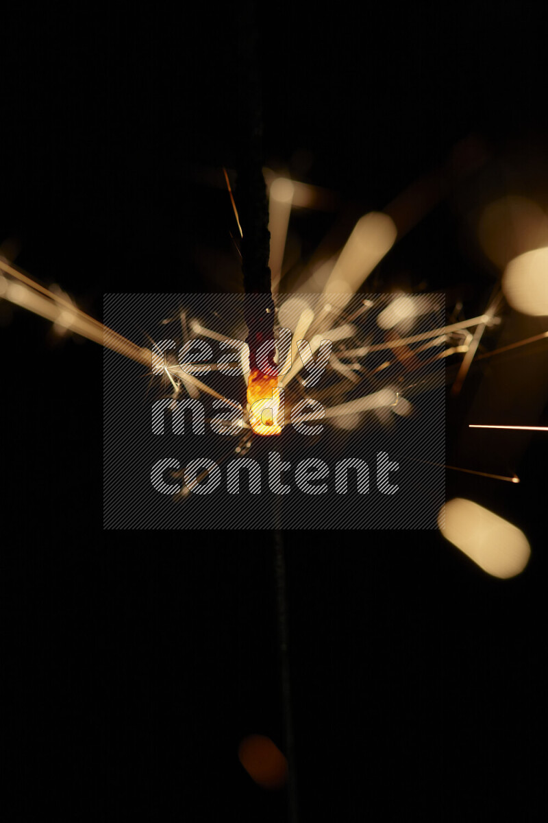 A close-up image of sparkler candle isolated on black background