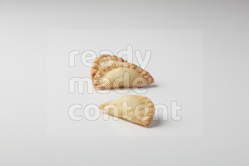 Three fried sambosas on a white background