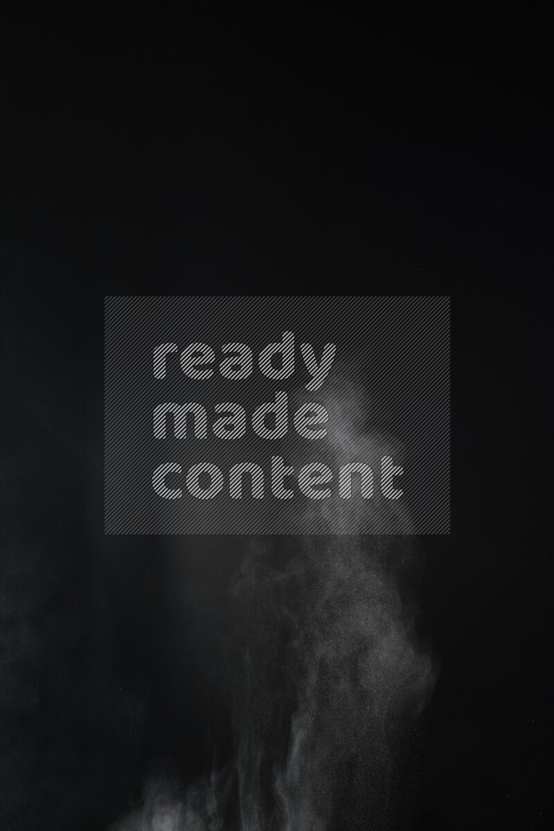 A side view of brown powder explosion on black background