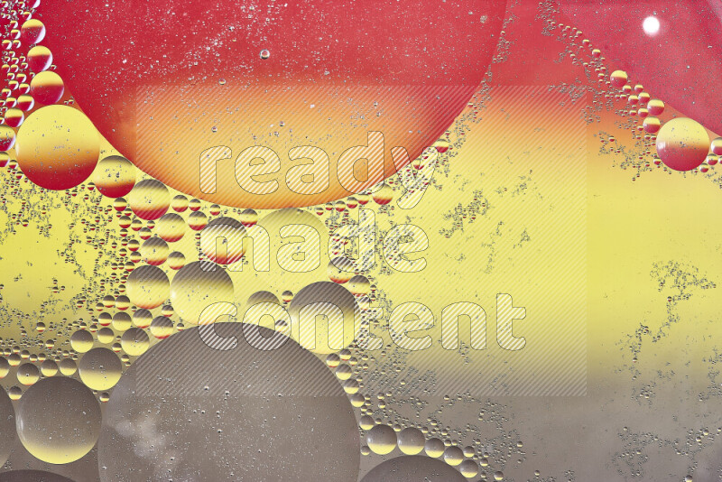 Close-ups of abstract oil bubbles on water surface in shades of yellow, red and brown
