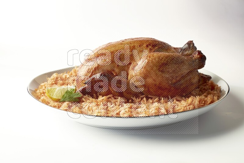 red basmati Rice with whole roasted chicken on a white plate with a silver rim direct on white background