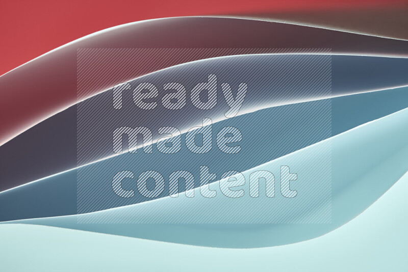 This image showcases an abstract paper art composition with paper curves in blue and red gradients created by colored light