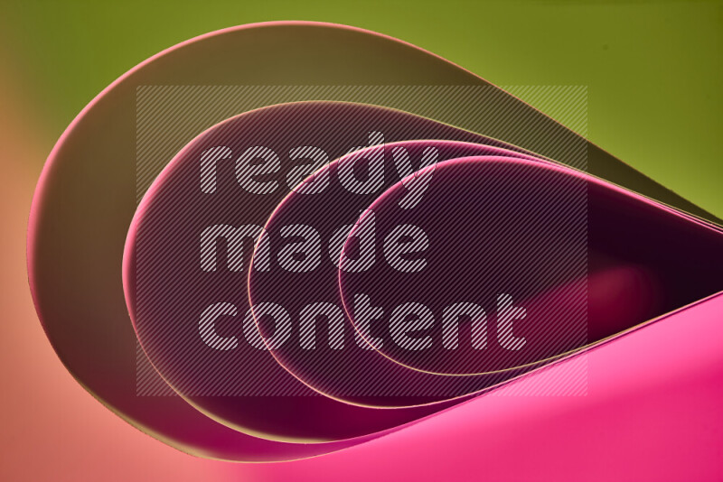 An abstract art of paper folded into smooth curves in green and pink gradients