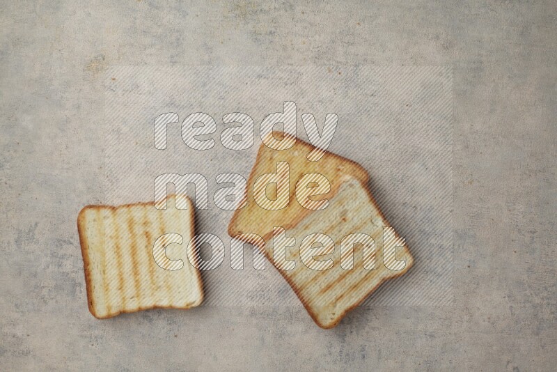 Toasted white Toast slices on a light blue textured background