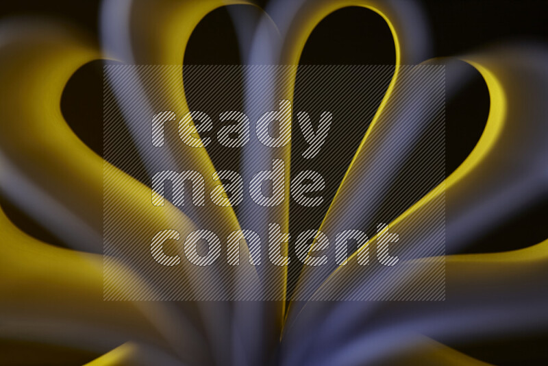 An abstract art piece displaying smooth curves in white and yellow gradients created by colored light