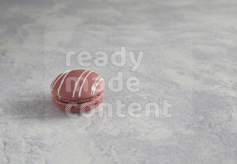 45º Shot of Red Poppy Flower macaron on white  marble background