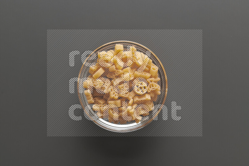 Shaped children pasta on grey background