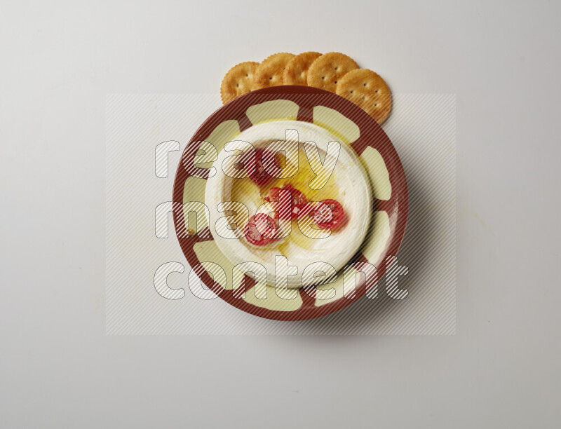 Lebnah garnished with Cherry tomato in a traditional plate on a white background