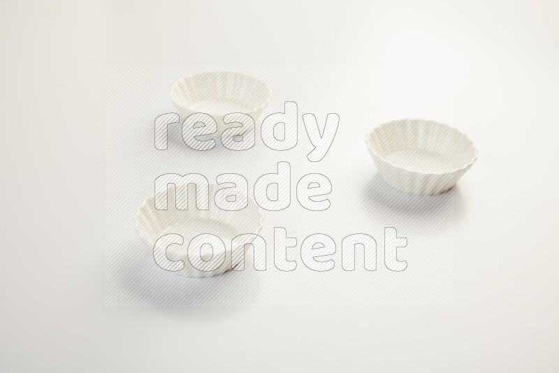 white ceramic round sauce dish on white countertop