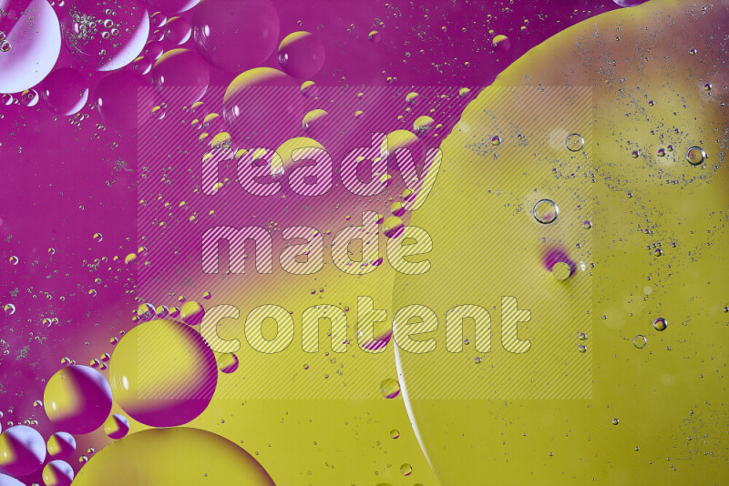 Close-ups of abstract oil bubbles on water surface in shades of yellow and pink