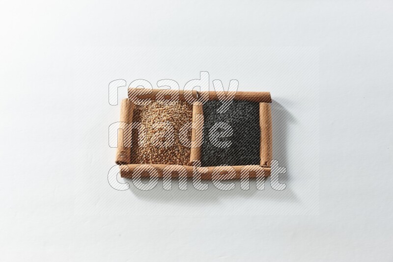 2 squares of cinnamon sticks full of mustard seeds and black seeds on white flooring