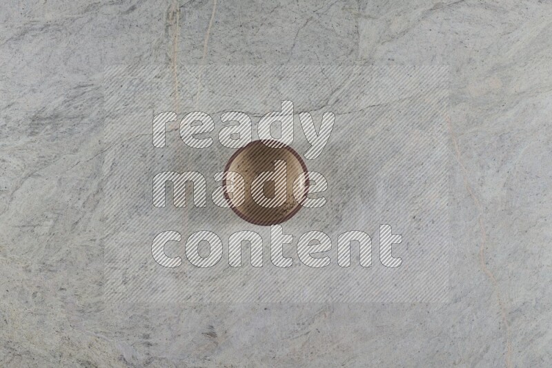 A multicolored pottery Bowl on grey marble background