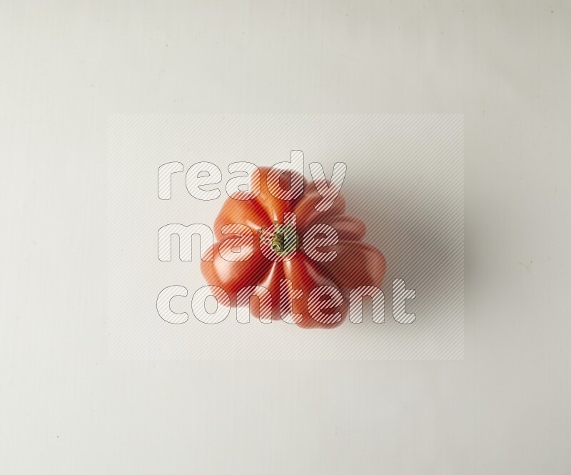Single topview Heirloom tomato on a white backgrounds