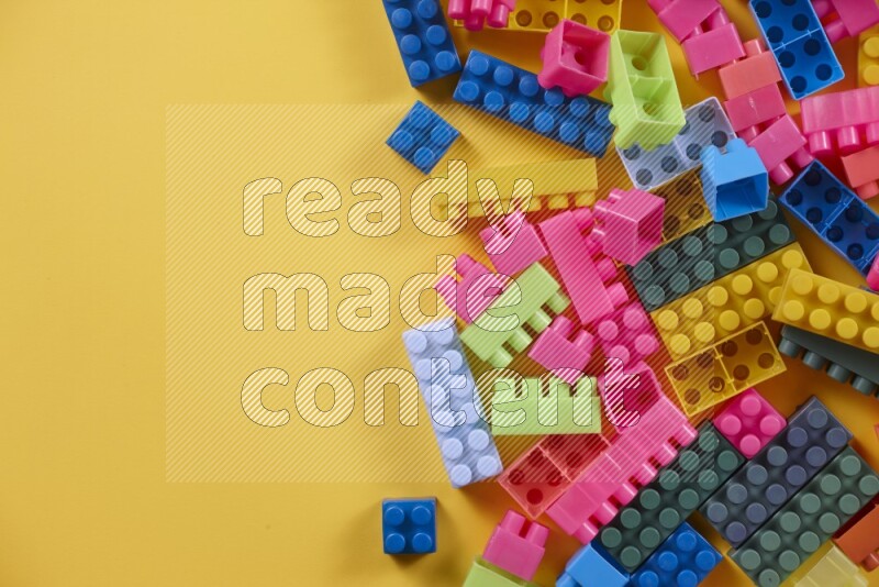 Multicolored plastic building blocks on different backgrounds (kids toys)