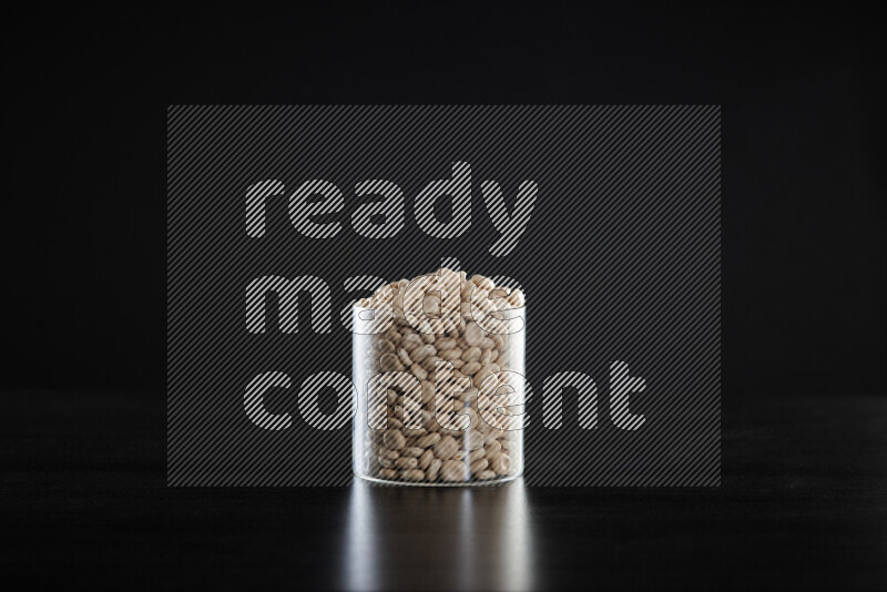 Lupin Beans in a glass jar on black background