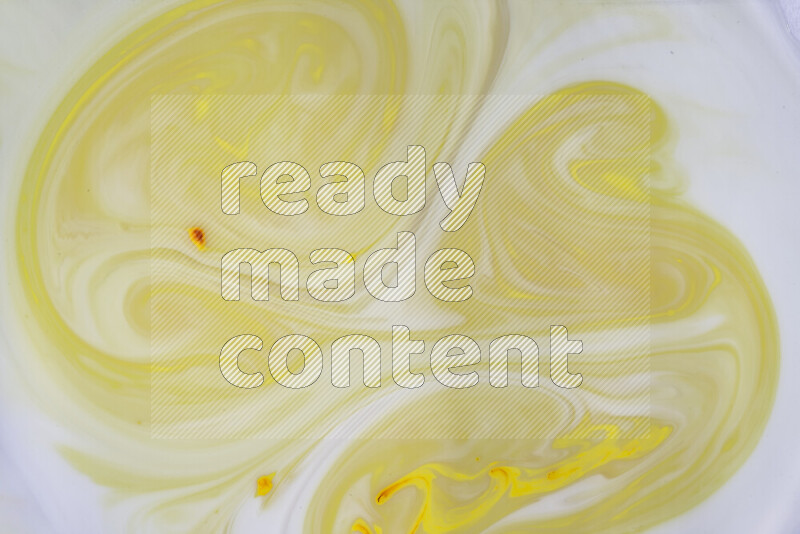 A close-up of abstract swirling patterns in yellow and white