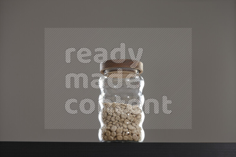 Lupin Beans in a glass jar on black background