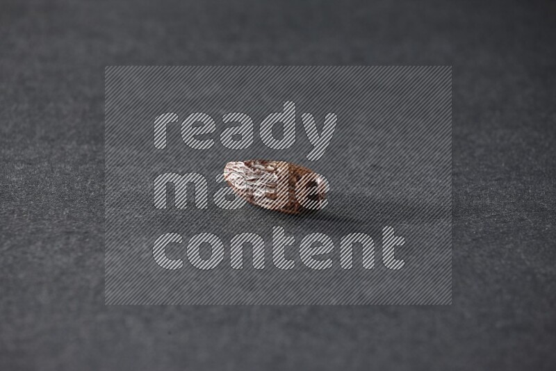 Dried dates on a black background in different angles