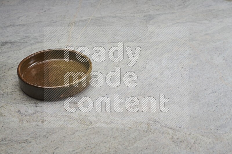A multicolored pottery oven plate on grey marble background