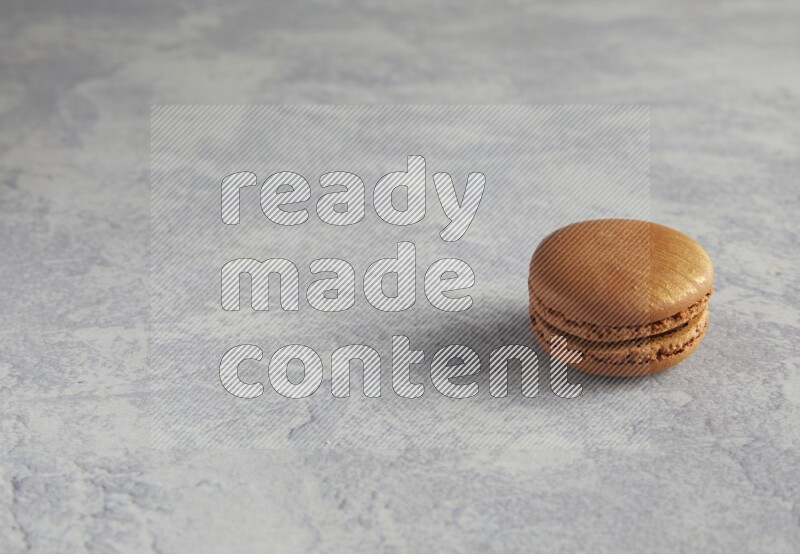 45º Shot of Brown Coffee macaron on white  marble background