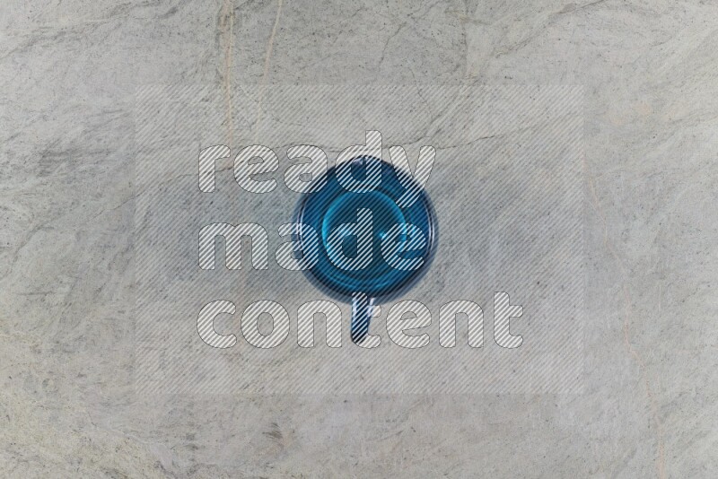 A colored glass jug on grey marble background