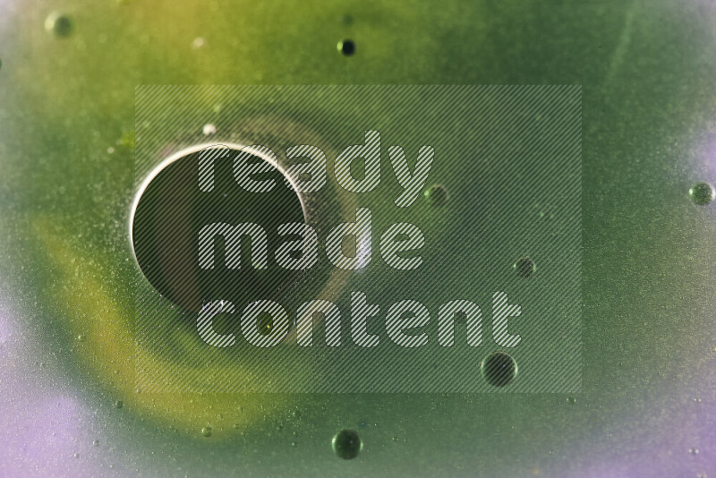 Close-ups of abstract yellow, blue and green watercolor drops on oil Surface on white background