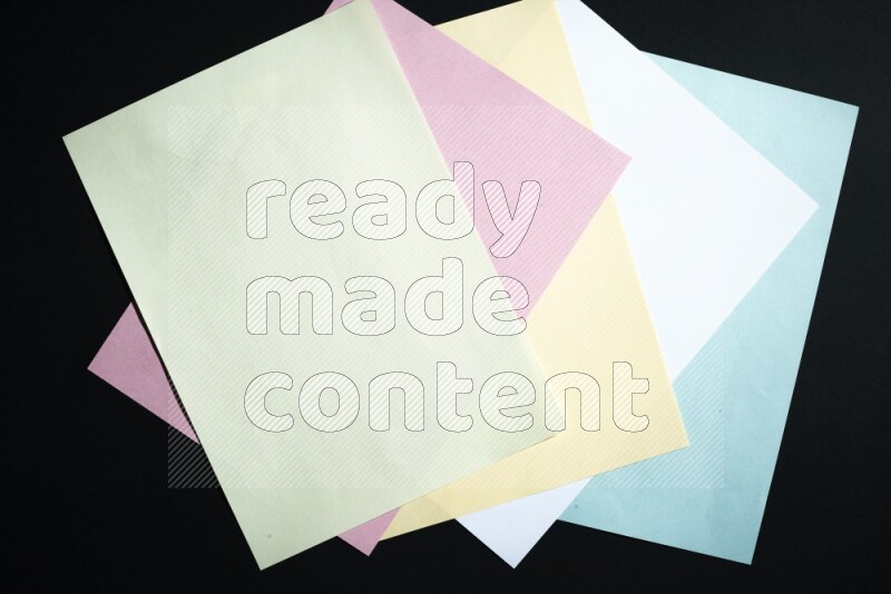 Multicolored paper sheet on black background