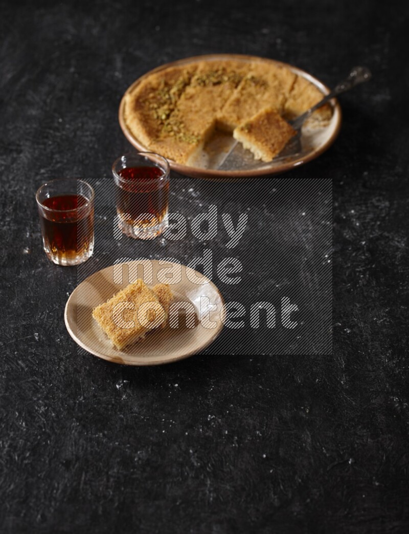 konafa with tea in a dark setup