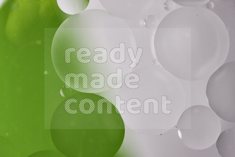 Close-ups of abstract oil bubbles on water surface in shades of white and green