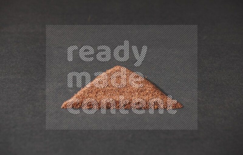 Garden cress seeds in a triangle shape on a black flooring