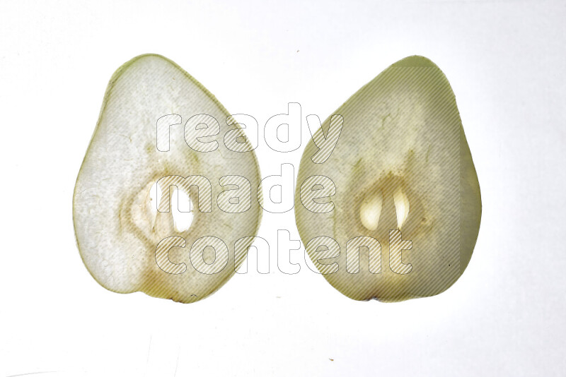 Pear slices on illuminated white background