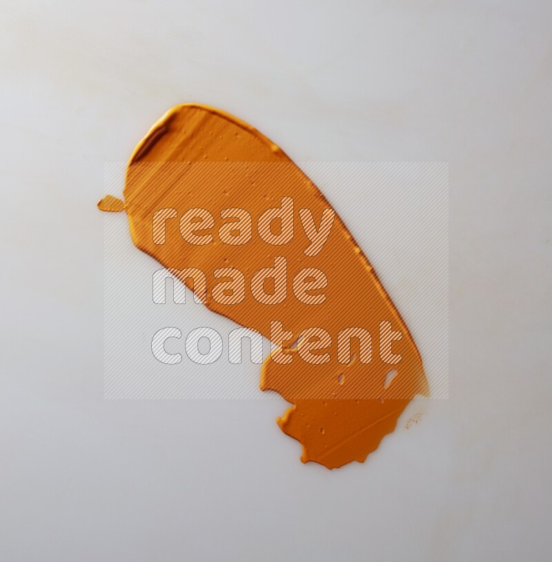 An orange single curved painting knife stroke on white background
