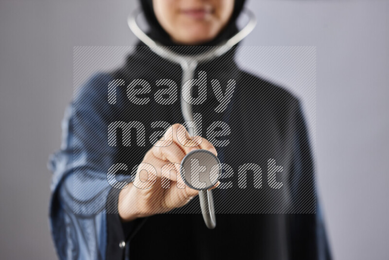 Female doctor wearing an abaya and medical attire in different positions