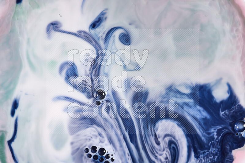 A close-up of abstract swirling patterns in red, green, white and blue