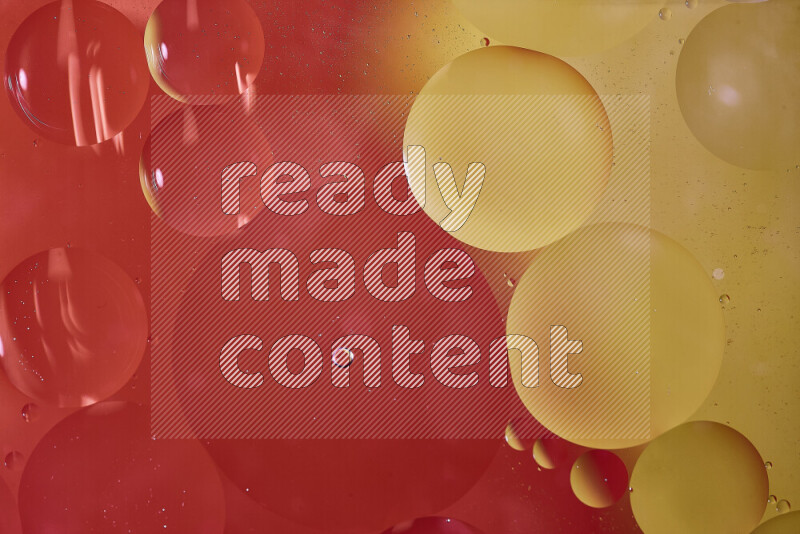 Close-ups of abstract oil bubbles on water surface in shades of red and yellow